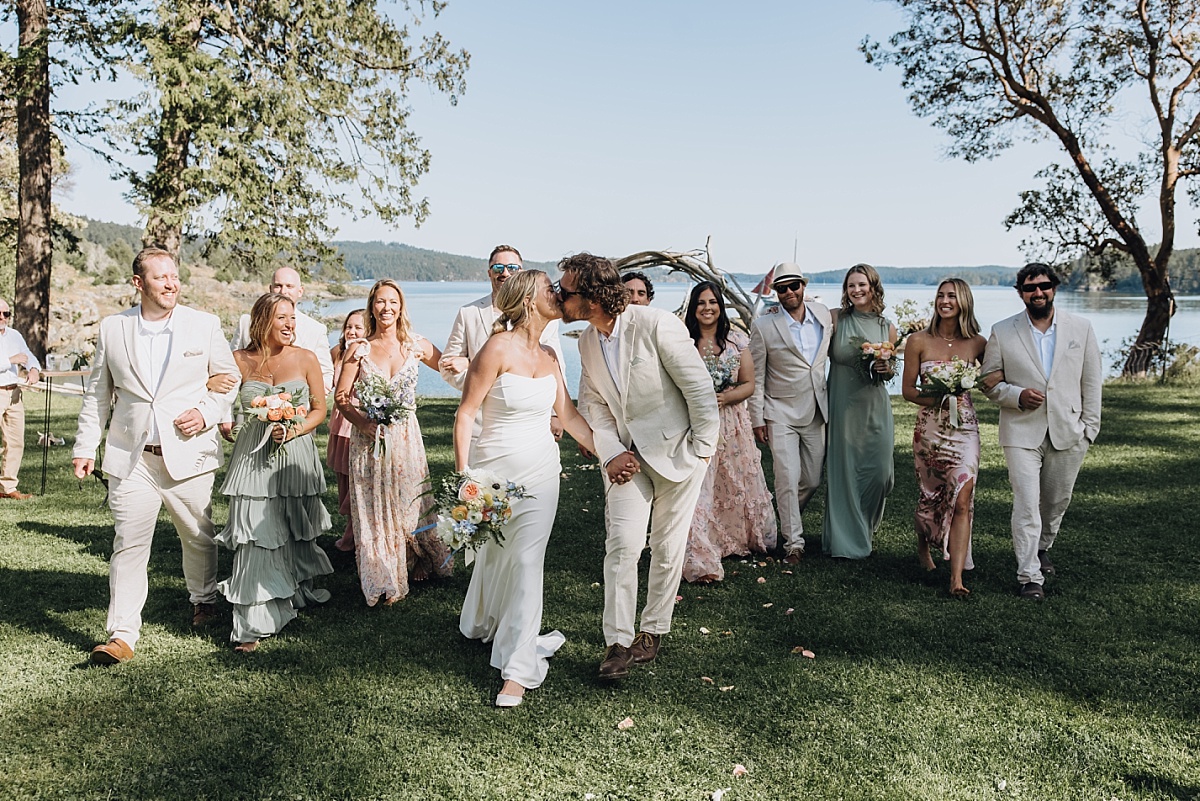 Wedding party walking through pebble cove venue on Orcas Island